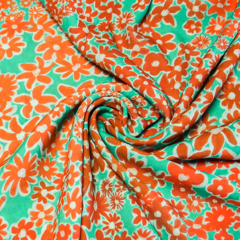 Étoffe 100% viscose - Fleur orange fond vert