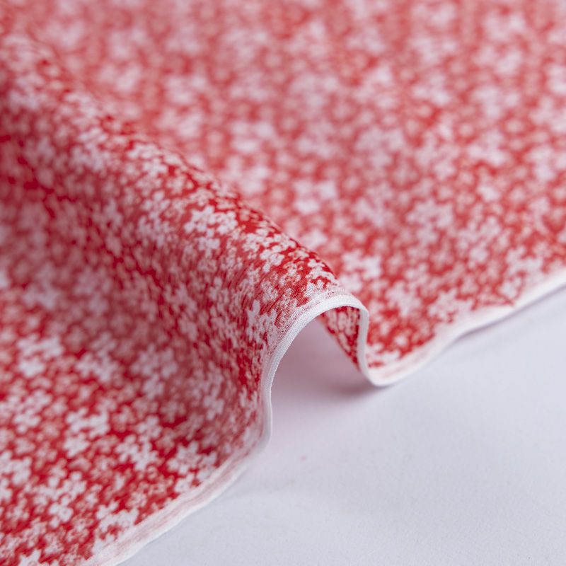 Mousseline crinkle 100% viscose – Fleurs blanches sur fond rouge